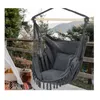 A hanging chair on a balcony with a natural background. Produktbild-Vorschau