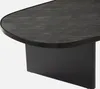 A close-up view of the corner of a black oval coffee table with a stone veneer top and a black base. Produktbild-Vorschau