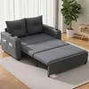 A gray sofa bed is shown in a living room setting with a plant and a side table in the background. Voir les images du produit