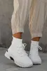 A person wearing beige cargo pants and white high-top sneakers. Produktbild-Vorschau