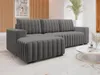 A modern living room with a gray sectional sofa, a round coffee table, and decorative plants. Náhľad obrázku produktu