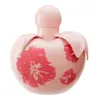 A pink perfume bottle with red floral designs on a white background. Anteprima dell’immagine prodotto