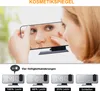 A woman is looking into a cosmetic mirror, and below are examples of the product's display settings. Produktbild-Vorschau