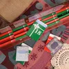 An advent calendar with small books or cards, arranged on a patterned fabric surface. Náhled obrázku produktu