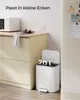 A kitchen scene with a white microwave on a counter and a white trash can with its lid open. Produktbild-Vorschau