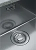 Close-up view of a stainless steel sink with a drain and a brand logo. Produktbild-Vorschau
