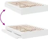 Two views of a white bed frame with drawers, showing the drawers closed and open. Podgląd zdjęcia produktu