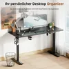 A modern standing desk setup with a computer, lamp, and organizer accessories. Produktbild-Vorschau