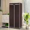 A portable wardrobe with brown fabric and white trim, placed next to a white cabinet in a room with tiled walls and a window. Podgląd zdjęcia produktu