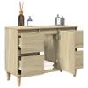 A wooden cabinet with open doors and drawers, displaying folded towels inside. Náhled obrázku produktu