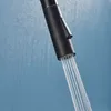 A close-up shot of a black faucet head with water spraying out. Produktbild-Vorschau