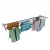 A clothes drying rack with various items of clothing hanging on it. Voir les images du produit
