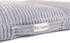 Close-up of a gray corduroy dog bed with a brand label. Náhľad obrázku produktu