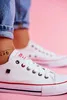 A close-up shot of a person wearing white Big Star sneakers. Voir les images du produit