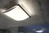 A ceiling light fixture mounted on a concrete ceiling. Produktbild-Vorschau