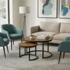 A living room scene with a couch, chairs, coffee tables, and artwork. Voir les images du produit