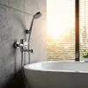 A modern bathroom with a bathtub and a wall-mounted faucet with a hand shower. Podgląd zdjęcia produktu