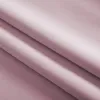 A close-up, angled view of folded pink fabric. Produktbild-Vorschau
