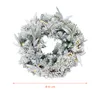A festive wreath decorated with artificial snow, berries, and lights. Náhled obrázku produktu