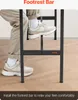 A person's legs and feet are shown resting on the footrest bar of a bar table. Produktbild-Vorschau