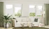 A bright and airy living room with a white sofa, coffee table, and large windows with green curtains. Produktbild-Vorschau
