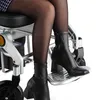 A close-up shot of a person's legs and feet in a wheelchair. Náhľad obrázku produktu
