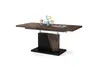 A modern dining table with a wooden top and a black base, set against a white background. Produktbild-Vorschau