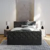 A bedroom scene featuring a tufted upholstered bed. Produktbild-Vorschau