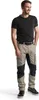 A man wearing work pants and a t-shirt, standing against a white background. Produktbild-Vorschau