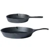 Two cast iron frying pans are shown against a white background. The pans are of different sizes, with the smaller one positioned above the larger one. Produktbild-Vorschau