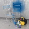 A painting setup with chairs, spray gun, compressor, and paint cans, suggesting a DIY or renovation project. Produktbild-Vorschau