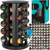 A black rotating spice rack with 20 glass jars filled with spices, displayed with a blue funnel and a box of stickers. The background is white. Podgląd zdjęcia produktu