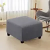 An ottoman is placed on a wooden floor in front of a window with sheer curtains. Produktbild-Vorschau