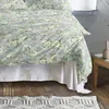 A close-up view of a bed with floral patterned bedding. Produktbild-Vorschau