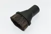 A close-up studio shot of a black vacuum cleaner brush attachment with natural bristles. Produktbild-Vorschau