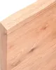 A close-up of a wooden tabletop with a natural edge. Náhled obrázku produktu