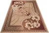 A modern rug with a floral pattern and a Greek key border, displayed on a white background. Produktbild-Vorschau