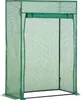 A green greenhouse with a roll-up door.