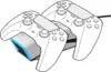 A white charging station for PlayStation 5 controllers with blue LED lights, shown with two controllers docked. Voir les images du produit