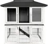 A two-story wooden hutch with wire mesh doors and a sloped roof, presented against a white background. Podgląd zdjęcia produktu