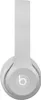 A close-up, front-facing view of a pair of gray Beats Solo 4 wireless headphones against a white background. Produktbild-Vorschau