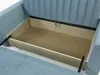 A close-up view of an open storage compartment within a blue sofa. Produktbild-Vorschau