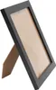 A black picture frame with a brown backing is shown at an angle against a white background. Produktbild-Vorschau
