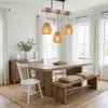 A dining room with a wooden table, chairs, and a pendant light. Produktbild-Vorschau