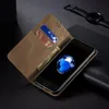 A brown leather wallet-style phone case is open, showing a phone with a blue abstract image on its screen, and a watch is visible in the background. Produktbild-Vorschau