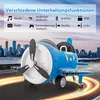 A blue and white toy airplane is shown in motion on a road with city buildings in the background. Text overlays describe its entertainment functions. Náhľad obrázku produktu