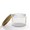 A clear glass jar with a gold screw-on lid, shown with the lid slightly ajar. Voir les images du produit