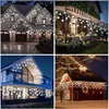 Collage of four images showing snowflake and round LED string lights decorating houses, a patio, and a barn. Anteprima dell’immagine prodotto