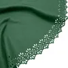 A close-up view of a green fabric with a decorative laser-cut edge. Náhľad obrázku produktu