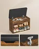 A wooden shoe storage bench with a black upholstered top, shown open with shoes on the shelves and items in the storage compartment. Náhled obrázku produktu